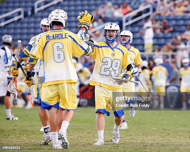 Kieran McArdle high-fives Kevin Cunningham of the Florida Launch during the first half of the game against the Ohio Machine at Florida Atlantic...