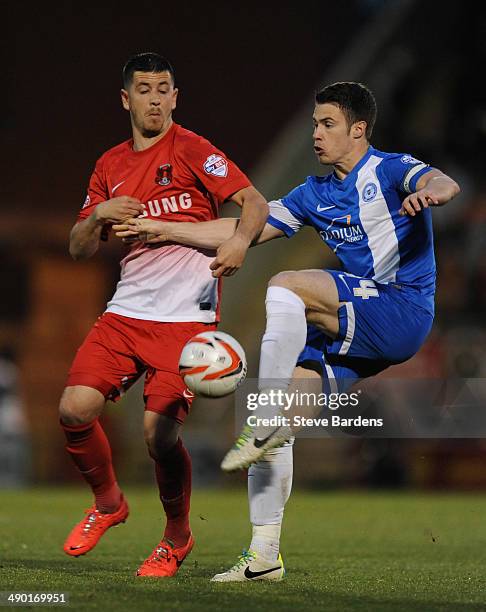 Tommy Rowe of Peterborough United challenges for the ball with Lloyd James of Leyton Orient during the Sky Bet League One play-off semi-final second...