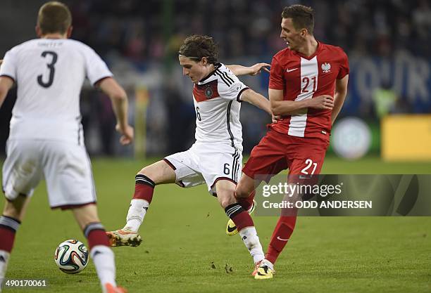 Germany's midfielder Sebastian Rudy vies with Poland's striker Arkadiusz Milik during the FIFA 2014 World Cup friendly football match Germany vs...