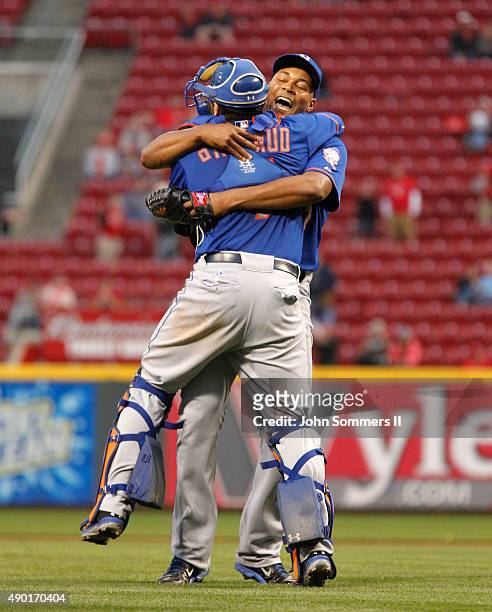 Jeurys Familia and Travis d'Amaud of the New York Mets celebrate after defeating the Cincinnati Reds 10-2 to clinch the National League East...