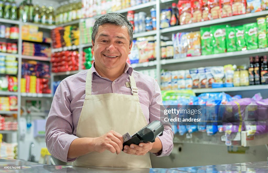 Business owner holding a credit card reader