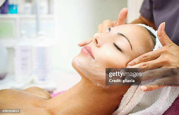 facial treatment at beauty salon. - massage table stock pictures, royalty-free photos & images