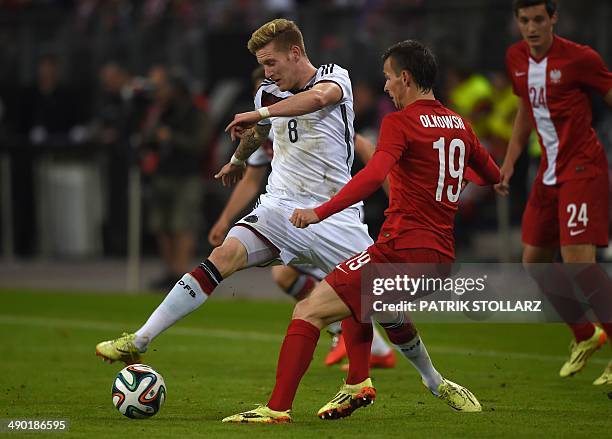 Germany's midfielder Andre Hahn and Poland's defender Pawel Olkowski vie for the ball during the friendly football match Germany vs Poland in...