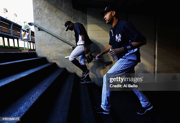 Derek Jeter and Alfonso Soriano of the New York Yankees walk on the field for batting practice before their game against the New York Mets at Yankee...