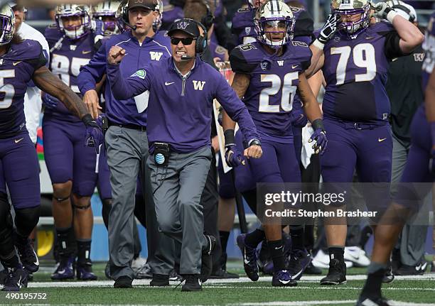 Washington Huskies head coach Chris Petersen celebrates a goal line stand against the California Golden Bears during the first half of a college...