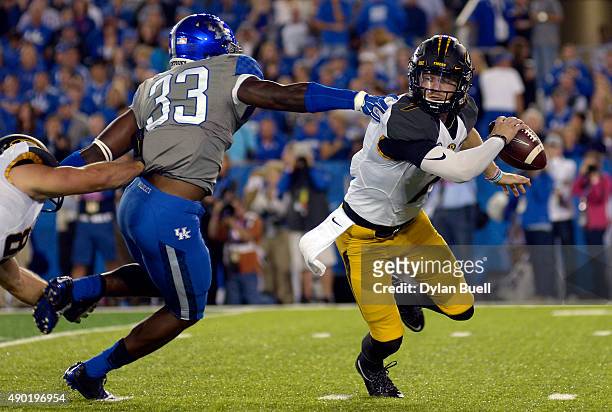 Maty Mauk of the Missouri Tigers avoids a sack attempt by Ryan Flannigan of the Kentucky Wildcats at Commonwealth Stadium on September 26, 2015 in...