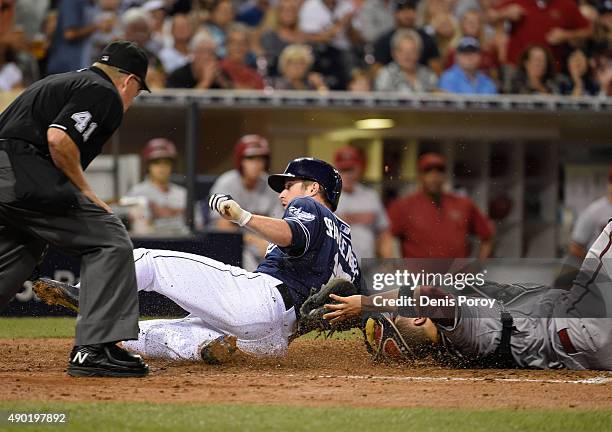 Cory Spangenberg of the San Diego Padres scores ahead of the tag of Welington Castillo of the Arizona Diamondbacks during the sixth inning of a...