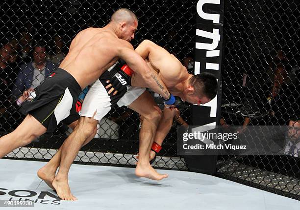 Diego Brandao of Brazil punches Katsunori Kikuno of Japan in their featherweight bout during the UFC event at the Saitama Super Arena on September...