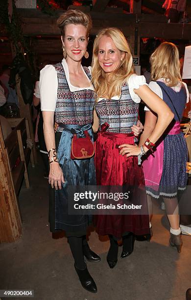 Isabel, Minzi zu Hohenlohe-Jagstberg and Princess Nadja zu Schaumburg - Lippe wearing the same Dirndl by Caroline Elleke, during the Oktoberfest 2015...