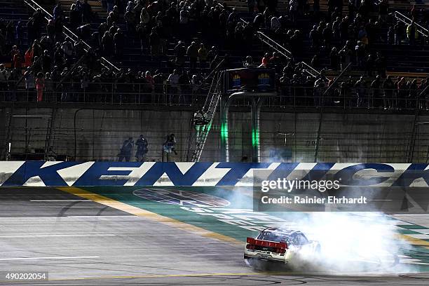 Ryan Blaney, driver of the Discount Tire Ford, celebrates with a burnout after winning the NASCAR Xfinity Series Visitmyrtlebeach.com 300 at Kentucky...