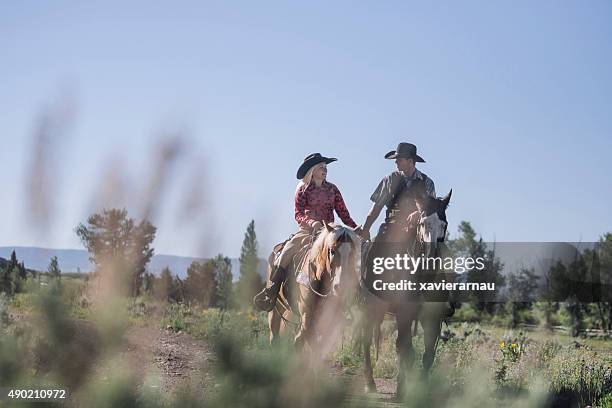 couple riding a horse in montana - flirting stock pictures, royalty-free photos & images