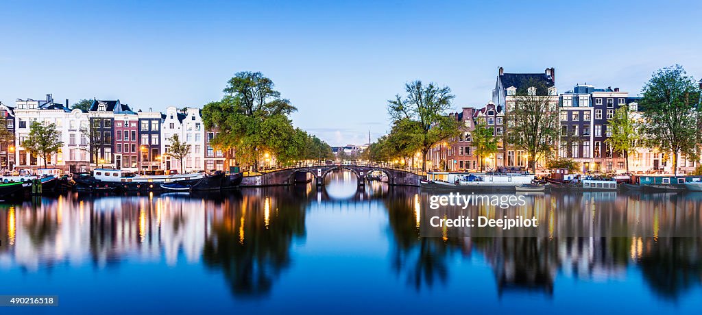 Bridges and Canals of Amsterdam Illuminated at Sunset Holland