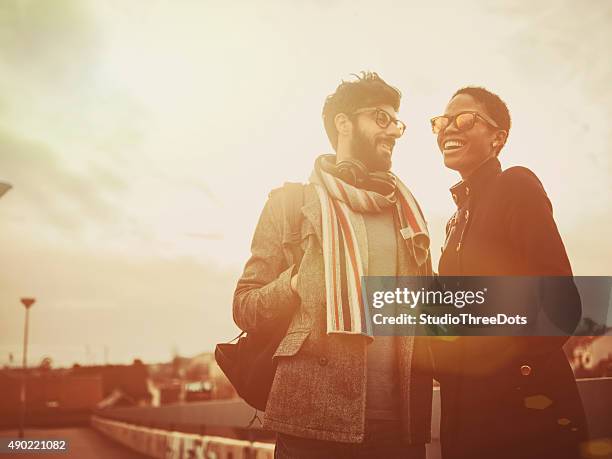 mixed race couple  walking on the street - suburban lifestyles stock pictures, royalty-free photos & images