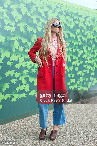 Model Laura Bailey wears a Prada coat, Jonathan Saunders sweater, vintage shirt, Penelope Chilvers shoes, Zanzan sunglasses and MiH jeans on day 3...