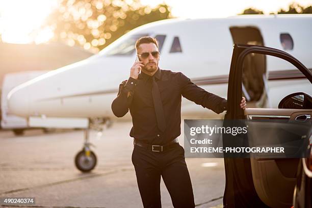 man in black on the airport track - bodyguard stock pictures, royalty-free photos & images