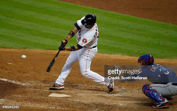 Carlos Corporan of the Houston Astros hits a three-run home run in the fifth inning of their game against the Texas Rangers at Minute Maid Park on...