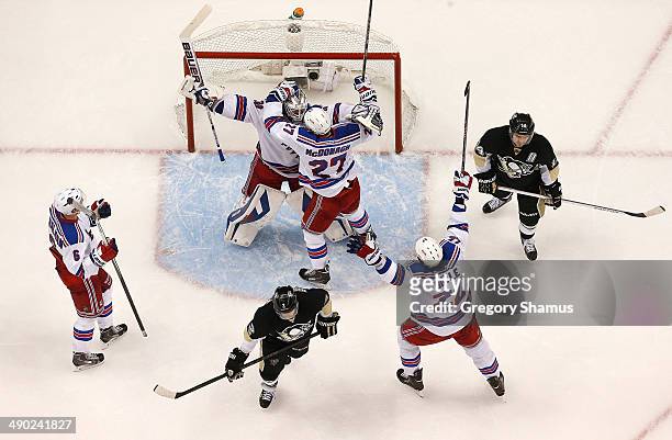 Henrik Lundqvist celebrates with Ryan McDonagh, Anton Stralman and Brian Boyle of the New York Rangers after beating the Pittsburgh Penguins 2-1in...