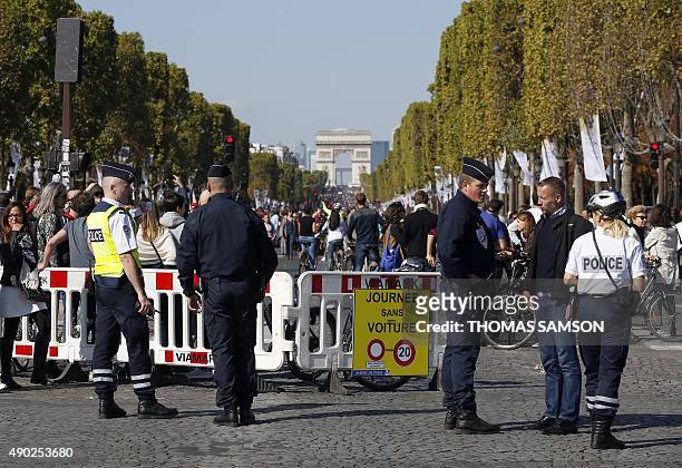 Police block the Champs Elysee Avenue during the "Car-Free Day" event taking place in the French capital Paris, and organised by the offices of mayor...