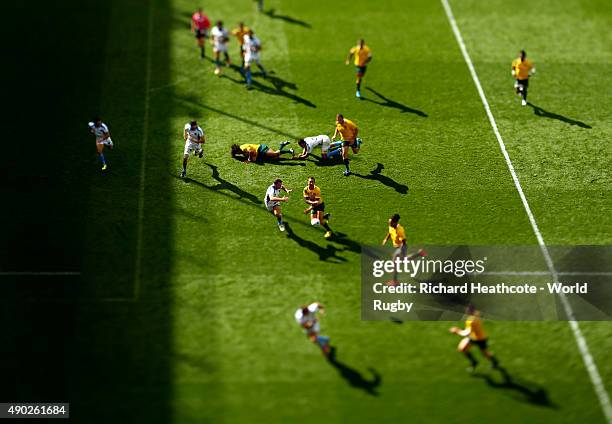 Quade Cooper of Australia passes the ball towards Drew Mitchell who runs in to score a try during the 2015 Rugby World Cup Pool A match between...