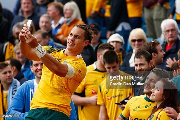 Matt Toomua of Australia poses for selfie photographs with fans after the 2015 Rugby World Cup Pool A match between Australia and Uruguay at Villa...