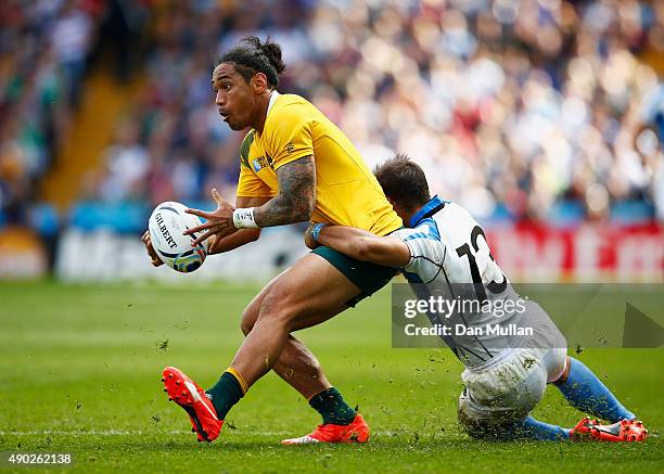 Joseph Tomane of Australia is tackled by Joaquin Prada of Uruguay during the 2015 Rugby World Cup Pool A match between Australia and Uruguay at Villa...