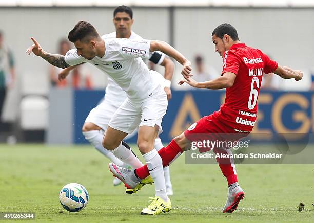 Lucas Lima of Santos and Willian of Internacional in action during the match between Santos and Internacional for the Brazilian Series A 2015 at Vila...