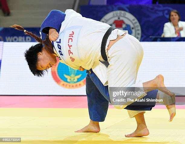 Mami Umeki of Japan throws Daria Pogorzelec of Poland in the Women's -78kg semi final during the 2015 Astana World Judo Championships at the Alau Ice...