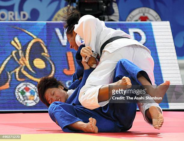 Fanny Estelle Posvite of France throws Chizuru Arai of Japan to win by Ippon in the Women's -70kg bronze medal match during the 2015 Astana World...
