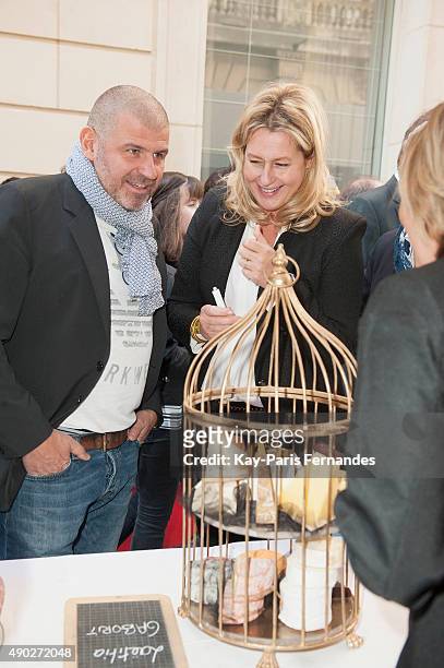 Michelin star chef Philippe Etchebest and Luana Belmondo speak to Cheese makers during the 'Fromage Fashion Week Menu' on September 27, 2015 in...