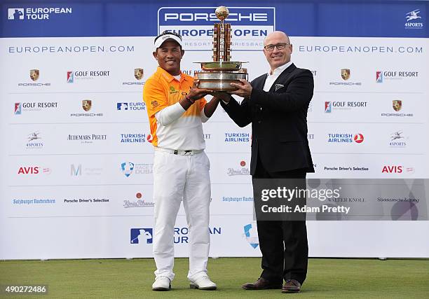 Thongchai Jaidee of Thailand is presented with the winners trophy by Bernhard Maier member of the board, sales and marketing Porsche AG after victory...