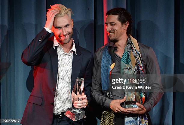 Singer-songwriter Adam Levine of Maroon 5 and producer/songwriter Jeff Bhasker accept the 2014 BMI Songwriter of the Year Award onstage at the 62nd...