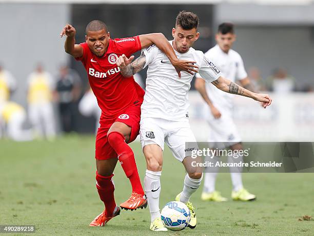 Ernando of Internacional and Lucas Lima of Santos in action during the match between Santos and Internacional for the Brazilian Series A 2015 at Vila...