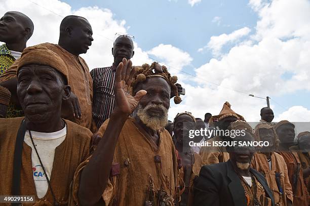 Traditional Ivorian Dozo hunters wait for arrival of Ivory Coast President Alassane Ouattara, in a street of Daloa, on September 27 during Ouattara's...