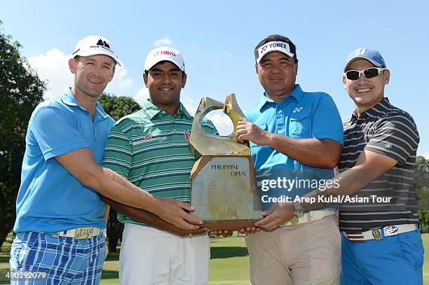 Berry Henson of USA, Anirban Lahiri of India, Mardan Mamat of Singapore and Angelo Que of Philippines pose with the trophy during the press...