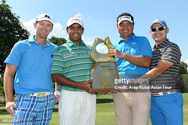 Berry Henson of USA, Anirban Lahiri of India, Mardan Mamat of Singapore and Angelo Que of Philippines pose with the trophy during the press...