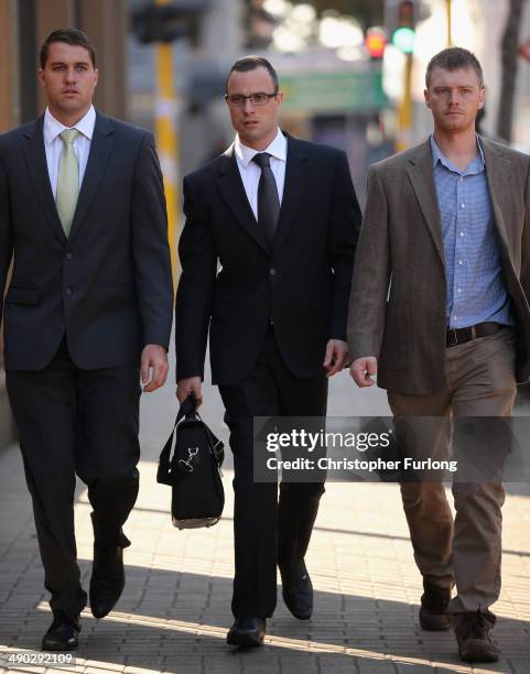 Oscar Pistorius arrives at North Gauteng High Court where he is facing trial accused of murdering his girlfriend Reeva Steenkamp on May 14, 2014 in...