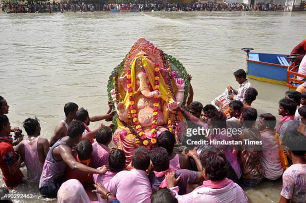 Devotees carry a statue of the Hindu God Ganesha to immerse in Yamuna River on the last day of the Ganesh Chaturthi festival at Ghaziabad on...