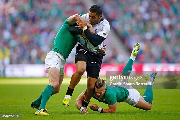 Paula Kinikinilau of Romania is tackled by Ian Madigan of Ireland during the 2015 Rugby World Cup Pool D match between Ireland and Romania at Wembley...