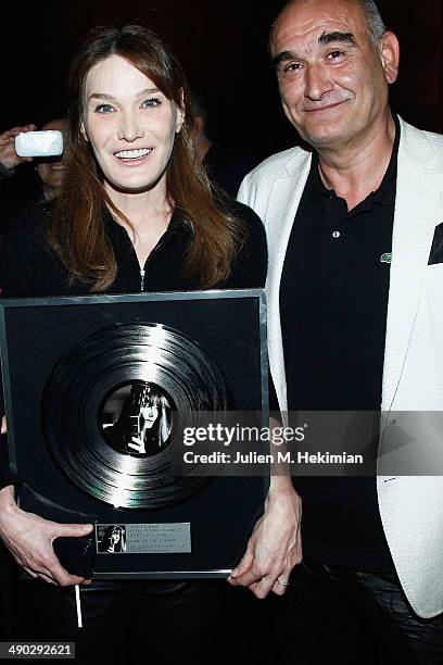 Italian singer and former First Lady of France Carla Bruni-Sarkozy is pictured with Universal Music France's CEO Pascal Negre, after receiving a...