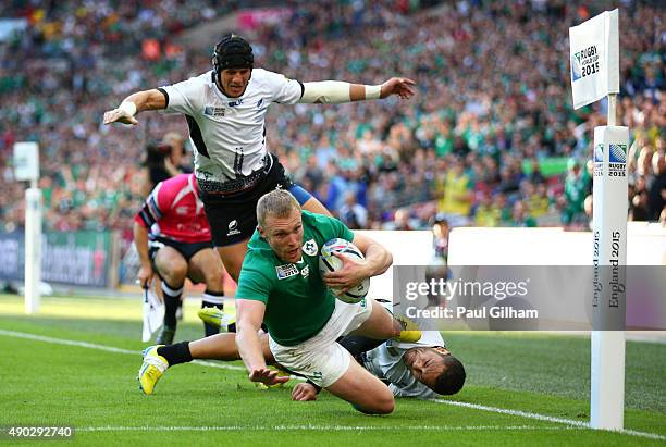 Keith Earls of Ireland scores his teams second try during the 2015 Rugby World Cup Pool D match between Ireland and Romania at Wembley Stadium on...