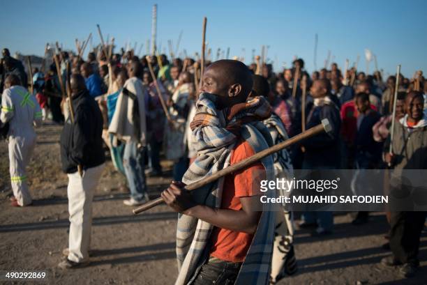 Striking miners march in Marikana, 40 kms from Rustenburg, in the South African platinum belt on May 14, 2014. Hundreds of striking miners marched at...