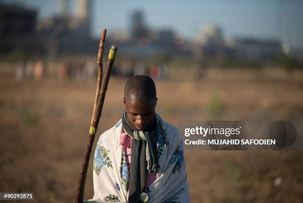 Striking miners march in Marikana, 40 kms from Rustenburg, in the South African platinum belt on May 14, 2014. Hundreds of striking miners marched at...