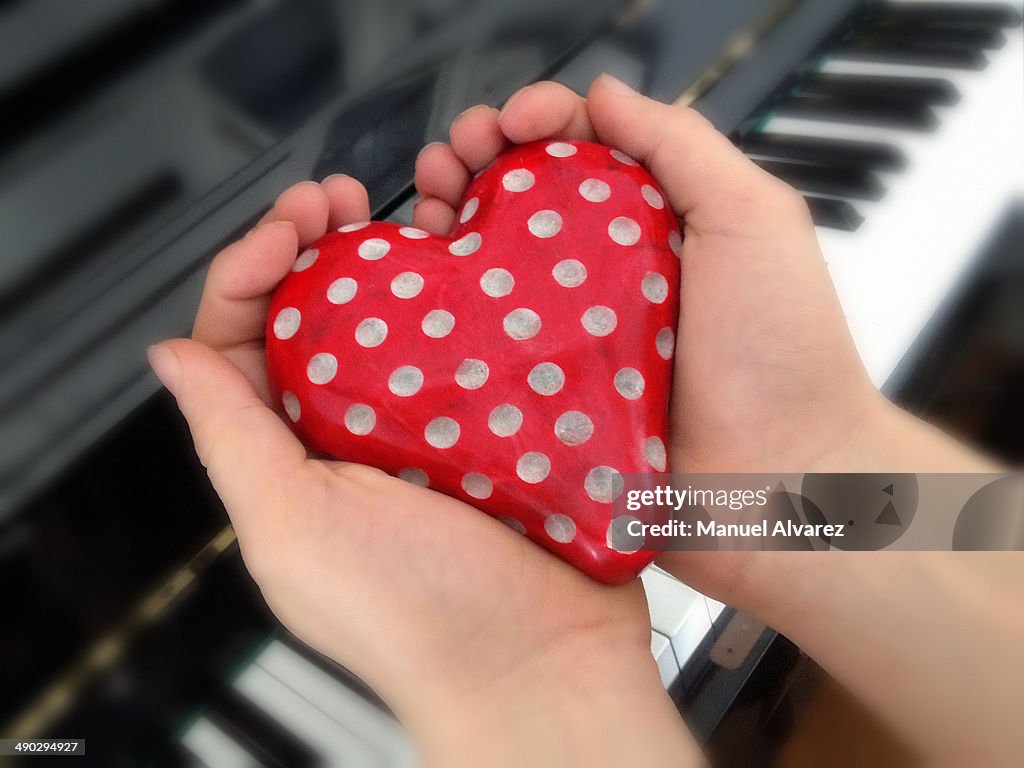 Heart in the hands of a young pianist