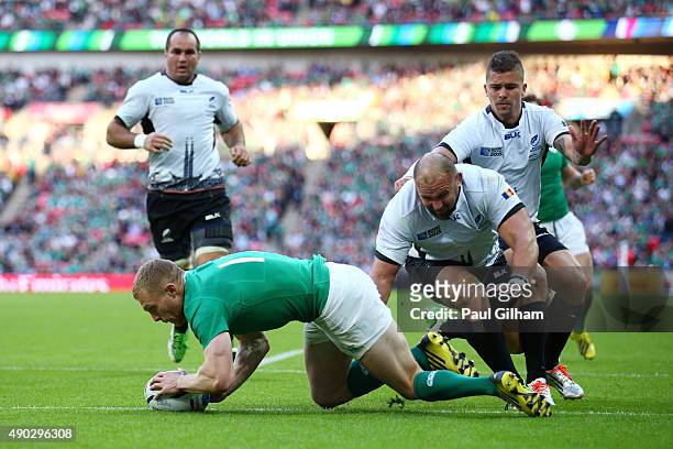 Keith Earls of Ireland scores his teams third try during the 2015 Rugby World Cup Pool D match between Ireland and Romania at Wembley Stadium on...