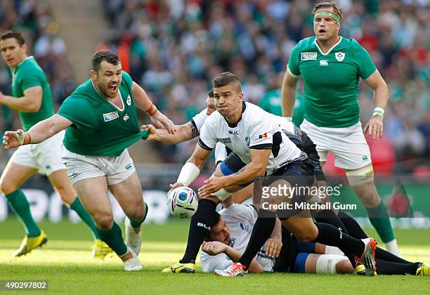 Valentin Calafeteanu of Romania throws a pass during the 2015 Rugby World Cup Pool D match between Ireland and Romania at Wembley Stadium, on...