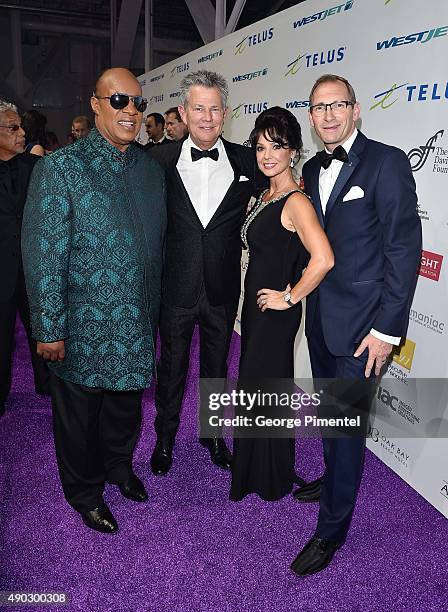 Stevie Wonder, David Foster, CEO of the David Foster Foundation, Michael Ravenhill and wife Cassandra Ravenhill attend David Foster Foundation...