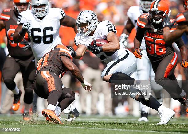 Roy Helu of the Oakland Raiders avoids a tackle by Donte Whitner of the Cleveland Browns during the first quarter at FirstEnergy Stadium on September...