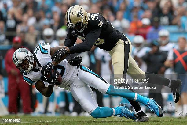 Ted Ginn of the Carolina Panthers makes a catch against Kenny Phillips of the New Orleans Saints in the first quarter during their game at Bank of...