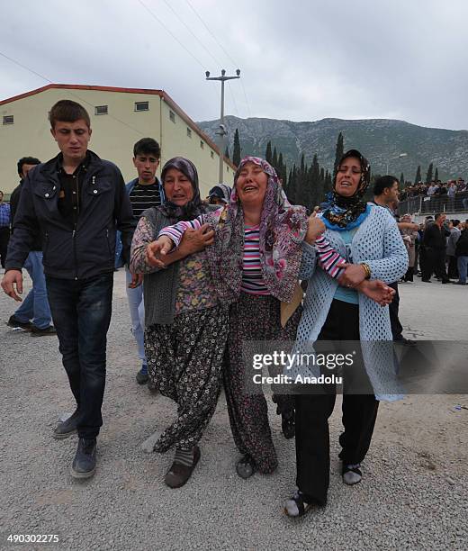 Relatives of the miners killed in the coal mine fire in Soma, mourn outside a cold storage house where dead bodies of victims were borught for...