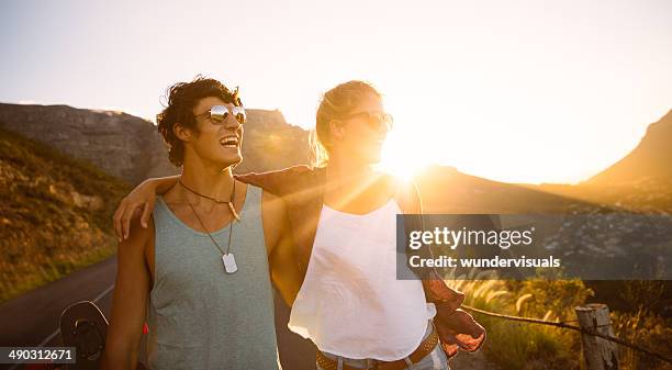 skater couple on street sunset - longboard surfing stock pictures, royalty-free photos & images